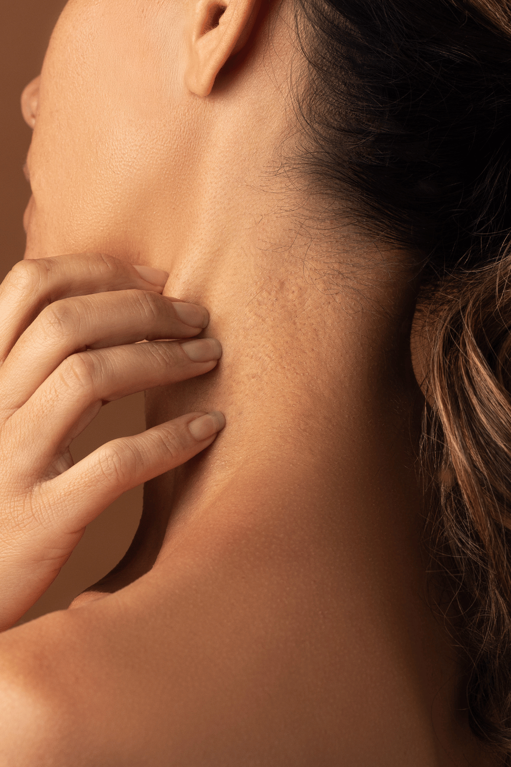 Woman scratching neck
