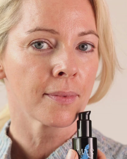 Model Holding Catalyst bottle and dropping some into hand