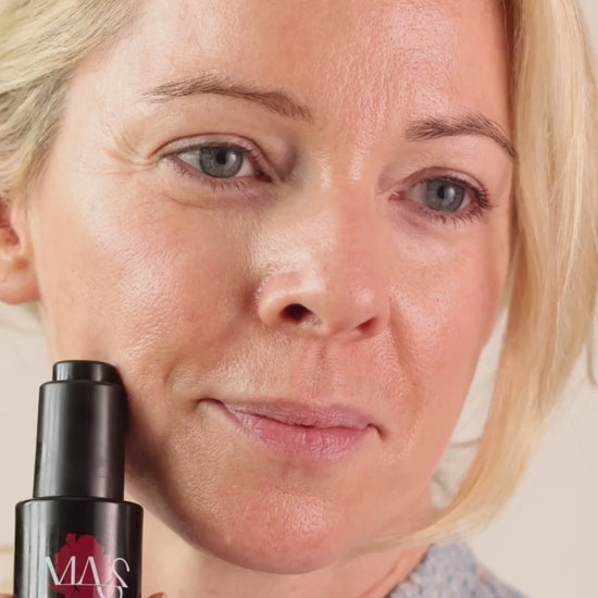 Model holding Innovator bottle and applying product to face