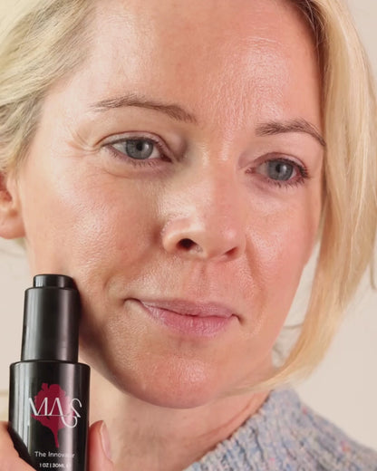 Model holding Innovator bottle and applying product to face